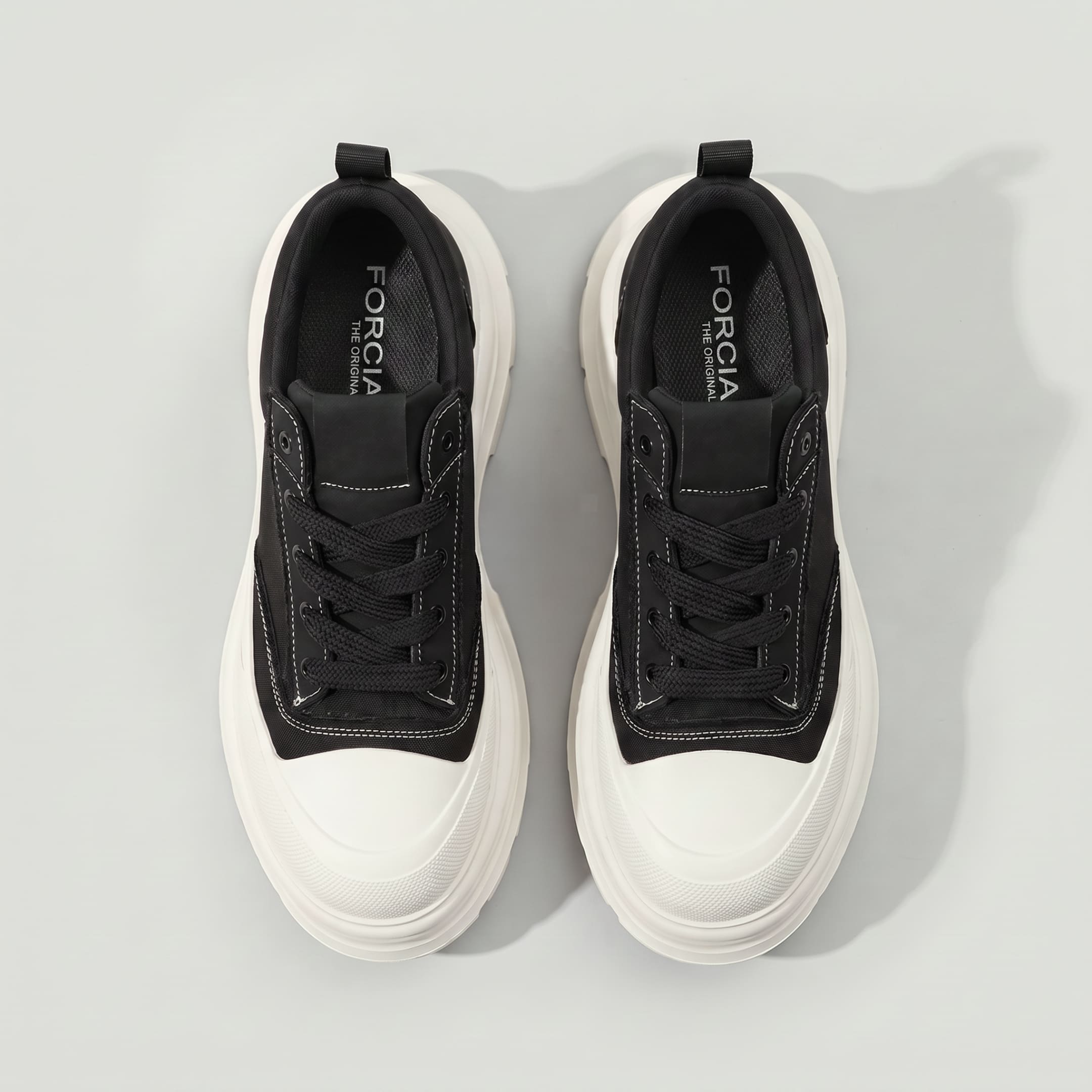 Top view of FORCIANO ATLAS Black elevator sneakers showing Black laces, contrast stitching, White toe caps and chunky White soles.