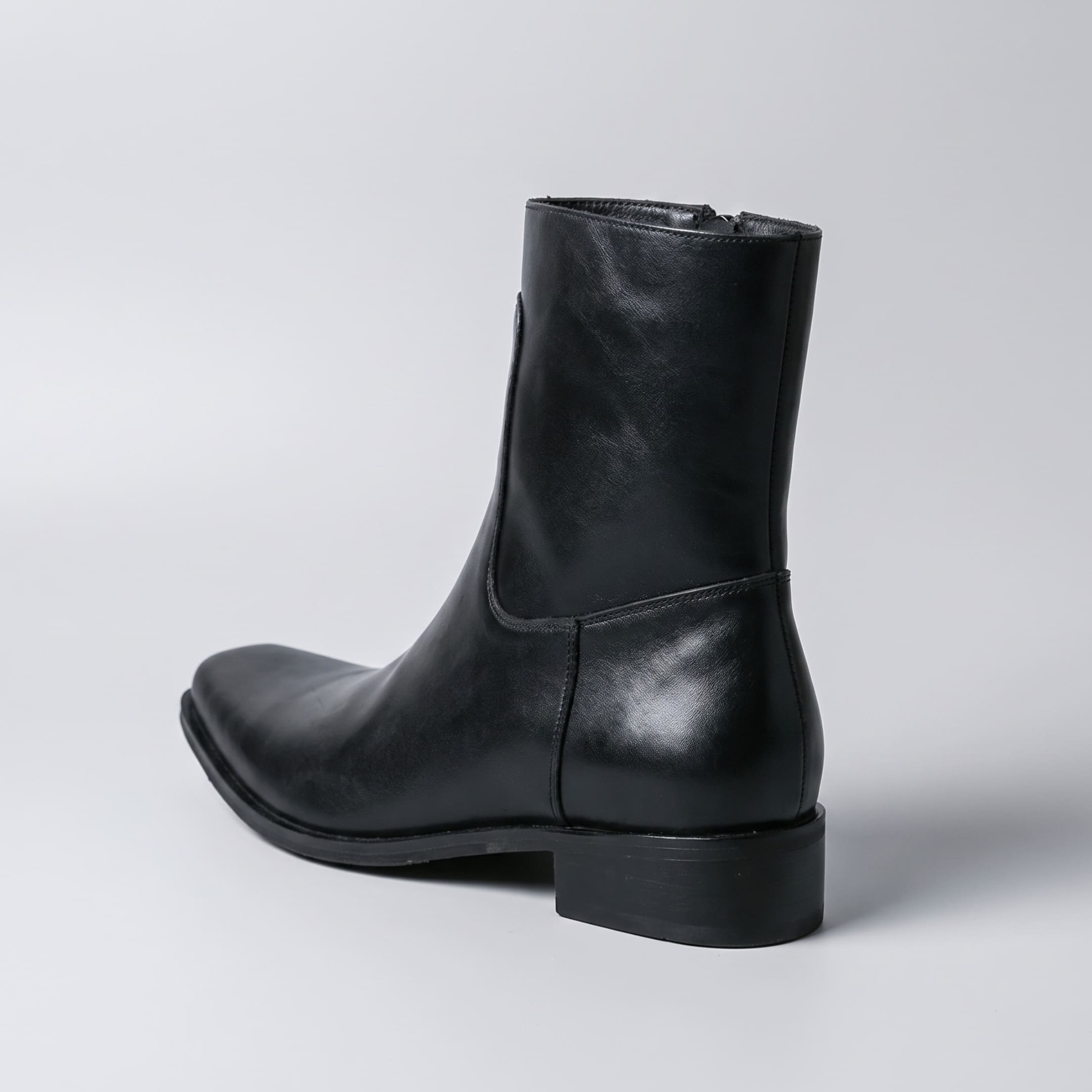 FORCIANO AURESTO black height increasing boot with smooth microfiber upper shown from the rear-side angle with heel construction visible.