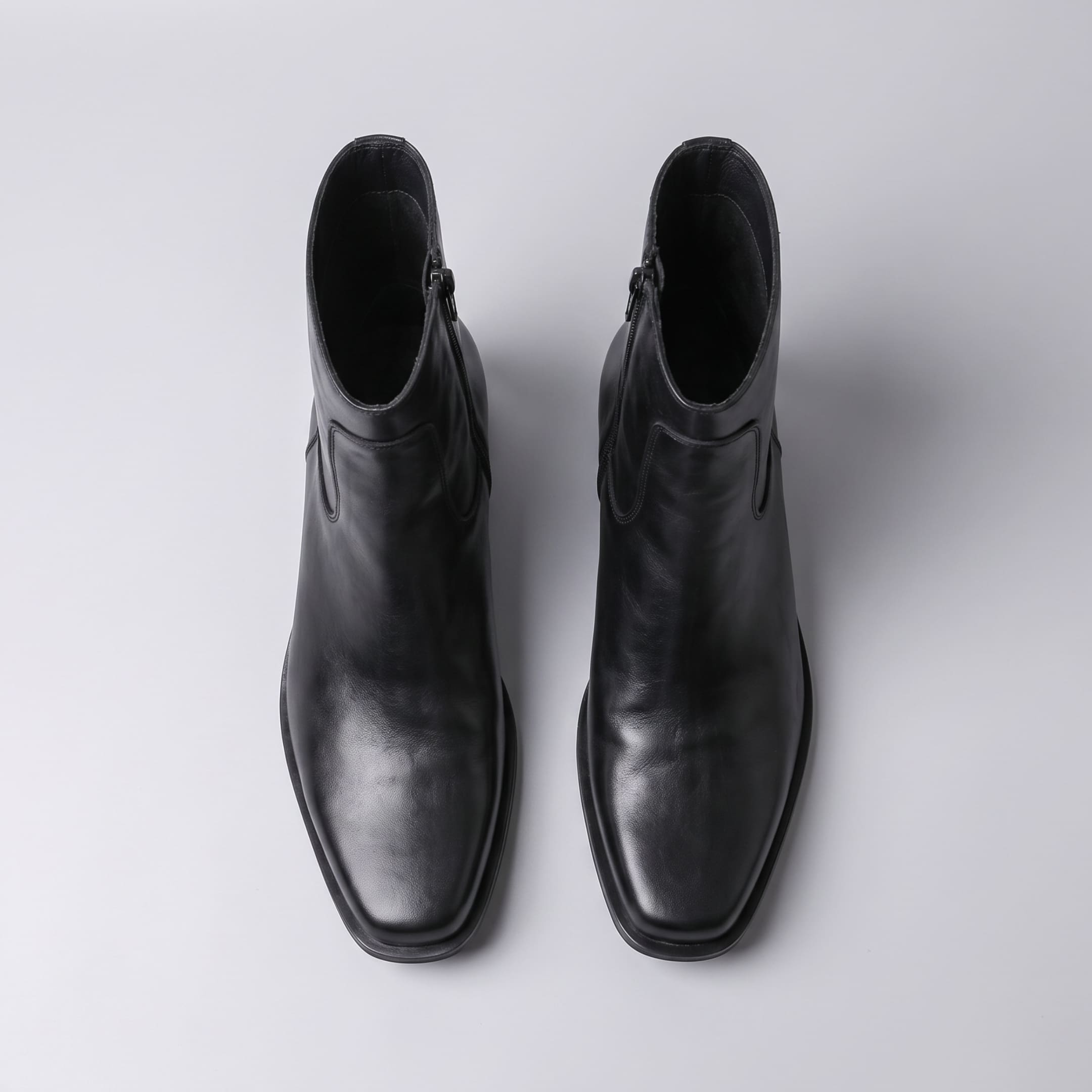 FORCIANO AURESTO black height increasing boots with smooth microfiber upper shown as a pair in top view with ankle openings visible.