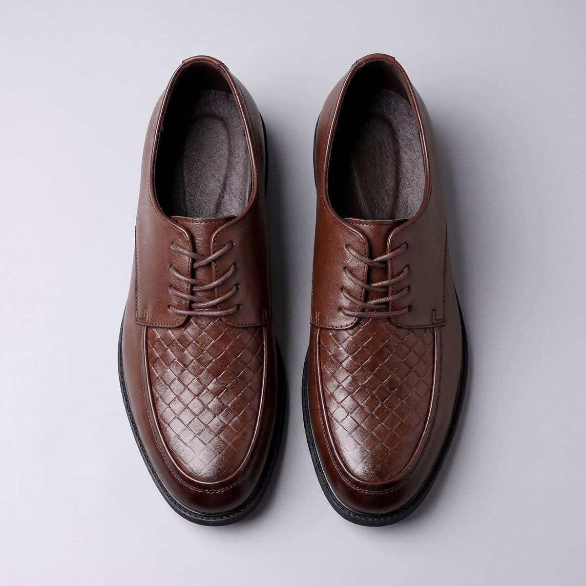FORCIANO AUTHORITY Height Increasing Shoes in Brown premium leather, shown as a pair from the top with laces and woven front panels visible.