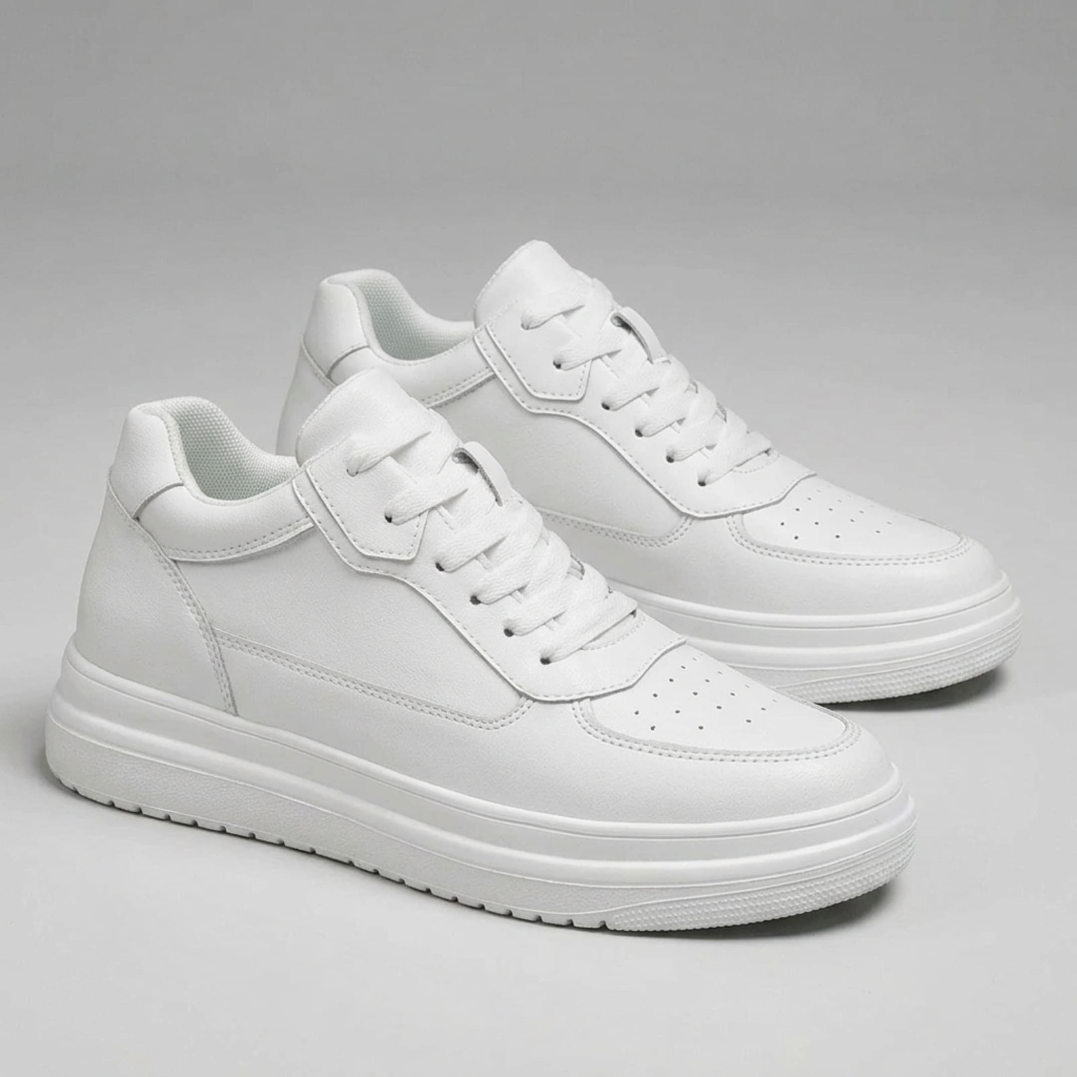 FORCIANO AVERY white sneakers for women shown as a pair from the front three-quarter angle with premium leather uppers and raised white soles.