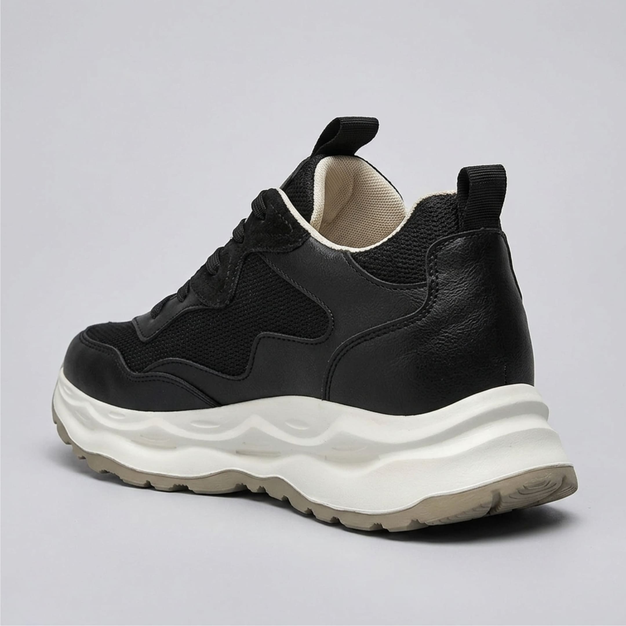 FORCIANO BELLUNO black height increasing sneaker with premium leather upper, shown from the rear three-quarter angle with raised sole profile visible.
