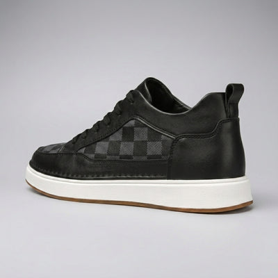 FORCIANO BELMONTE black leather Height Increasing Sneakers with a dark checkered side panel, shown from a rear three-quarter angle with the heel pull tab and white sole visible.