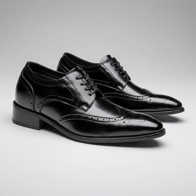 FORCIANO BROGUE black premium leather elevator dress shoes shown as a pair from a front three-quarter angle with polished brogue detailing.