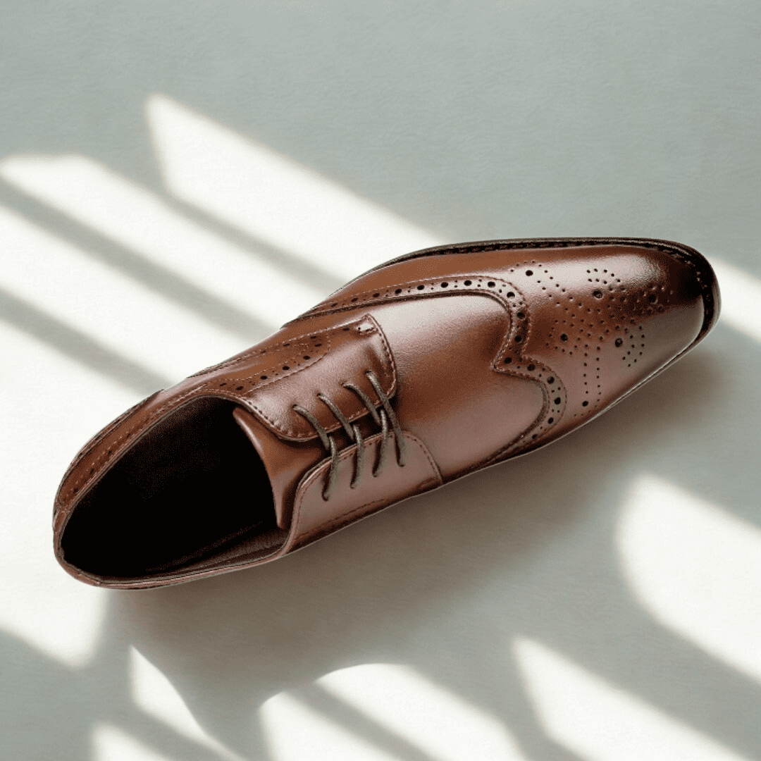 FORCIANO BROGUE brown premium leather elevator dress shoe shown from a top three-quarter angle with wingtip perforations and lace-up design.