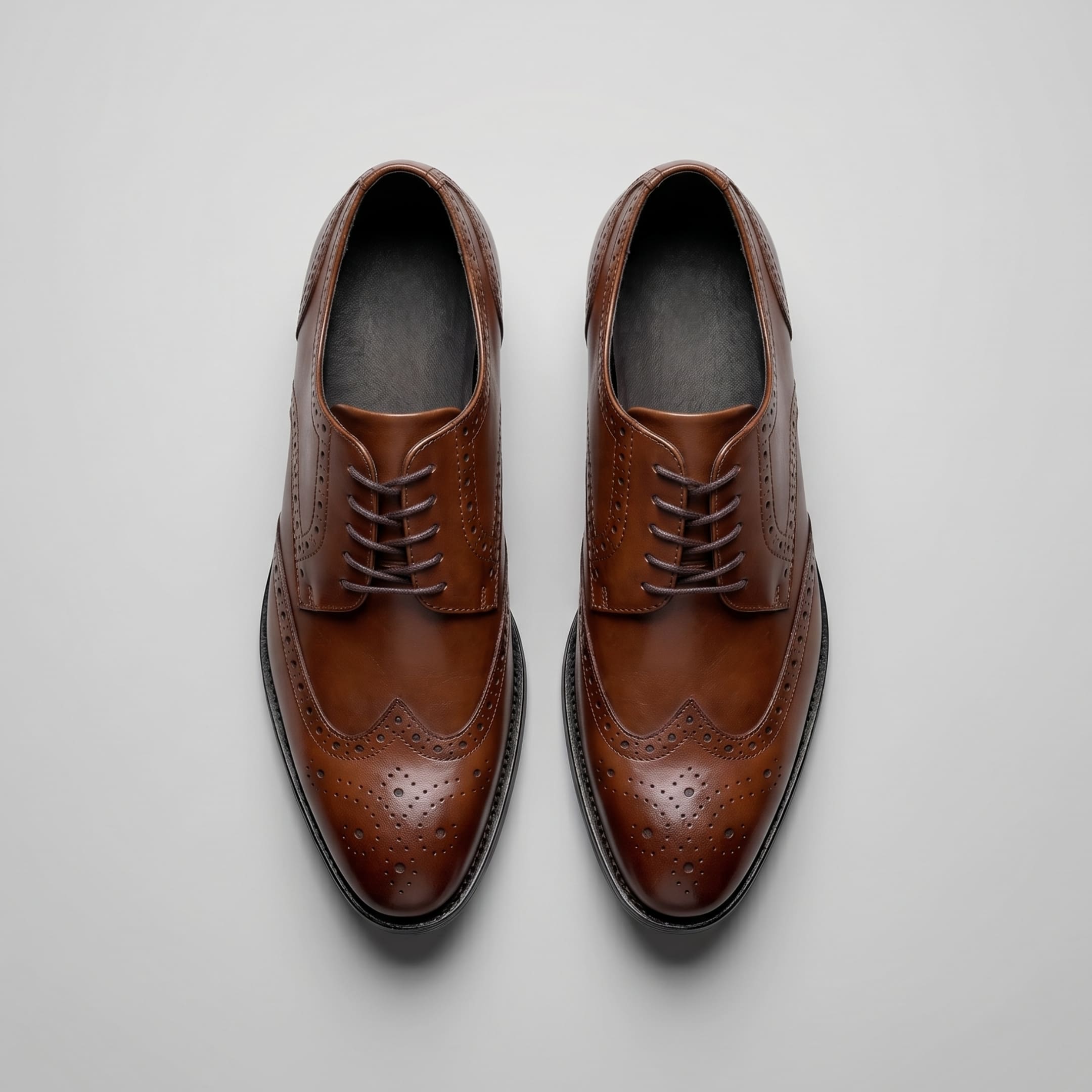 FORCIANO BROGUE brown premium leather elevator dress shoes shown as a pair from the top, highlighting laces and wingtip brogue detailing.