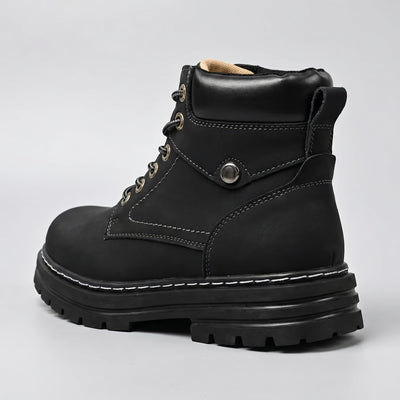 FORCIANO CALIBER black elevator boot with premium suede upper shown from a rear three-quarter angle with heel loop and chunky sole visible.