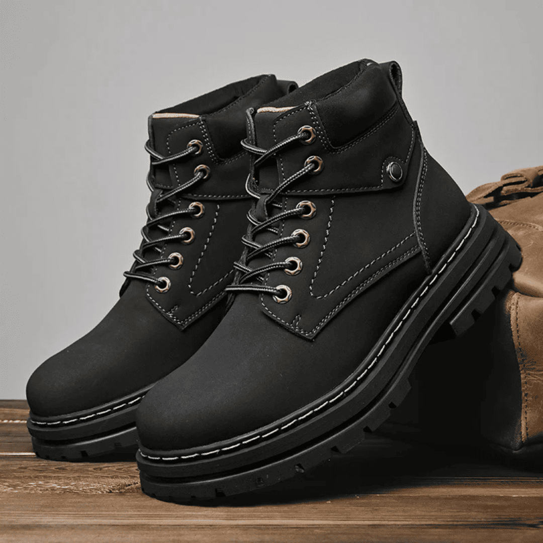 FORCIANO CALIBER black elevator boots with premium suede uppers shown as a pair in a styled lifestyle scene with their chunky soles visible.