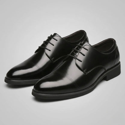 Pair of FORCIANO CAVELLO black elevator dress shoes with premium leather uppers shown from a front three-quarter studio angle.