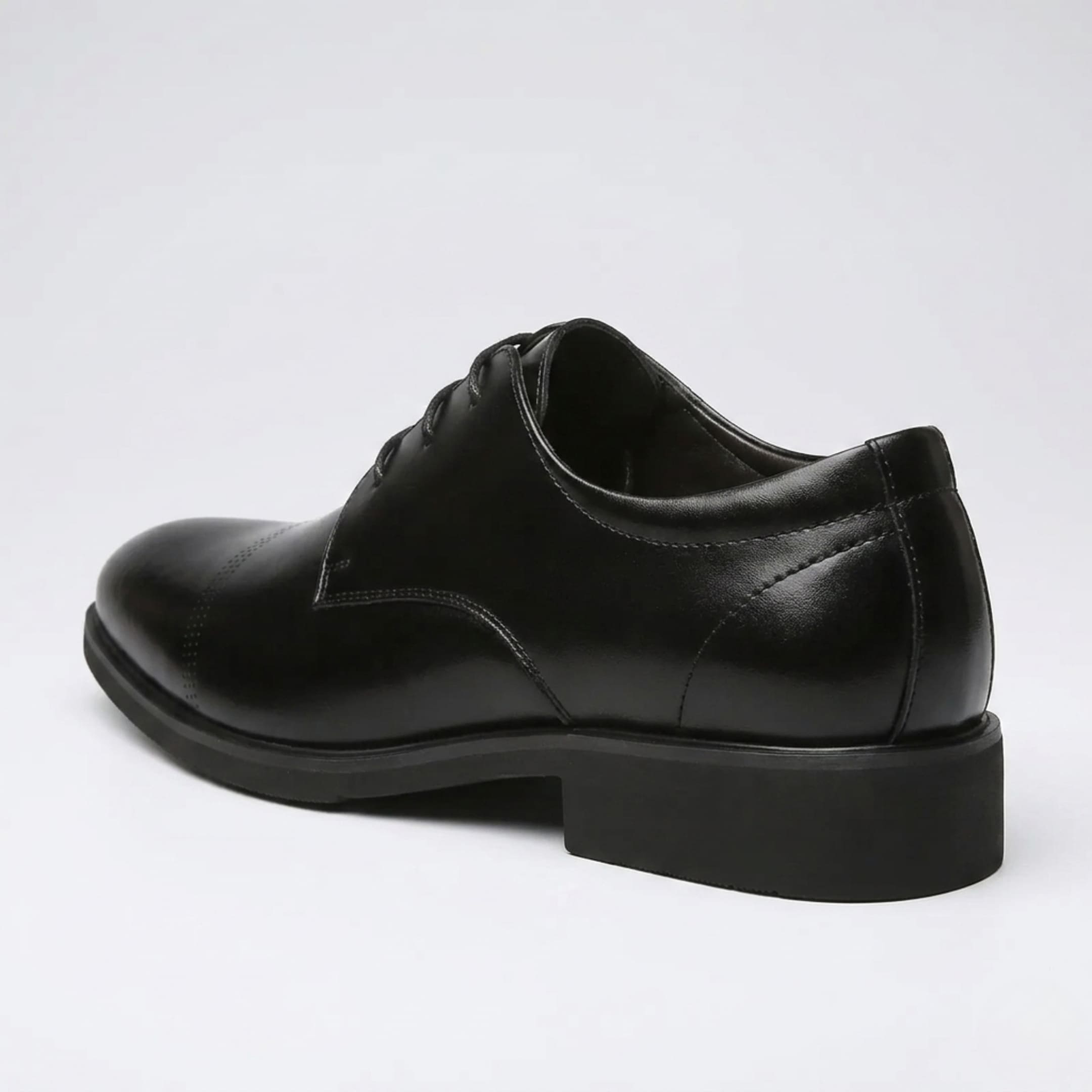 Rear three-quarter view of a FORCIANO CAVELLO black elevator dress shoe with premium leather upper showing the heel construction and side profile.