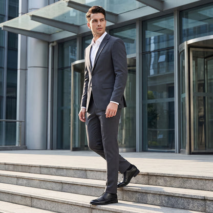 FORCIANO CAVELLO black perforated elevator dress shoes with premium leather uppers worn by a suited model walking down outdoor steps.