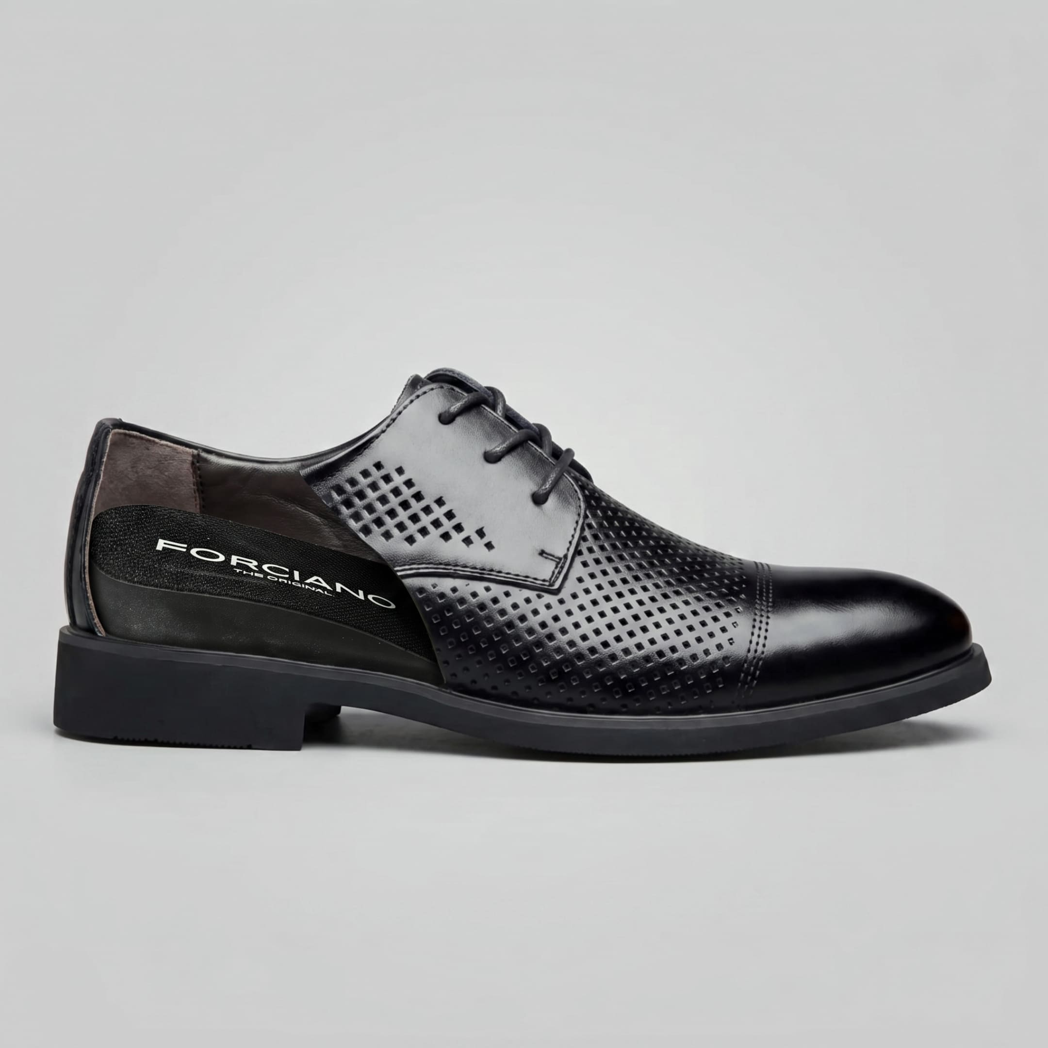 Side cutaway of FORCIANO CAVELLO black perforated elevator dress shoes showing one premium leather shoe with the internal height-increasing structure exposed.