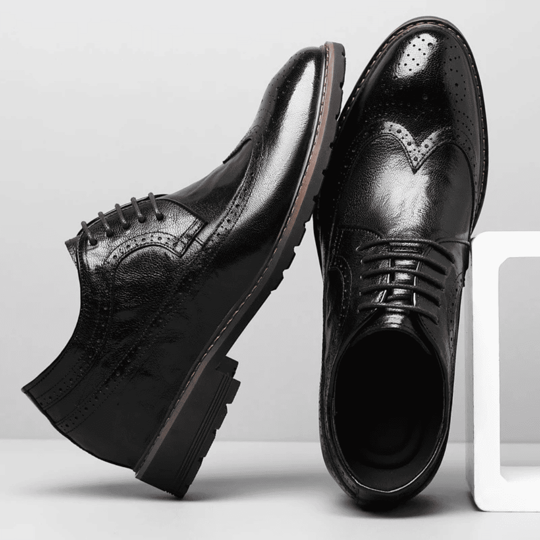 FORCIANO CELSUS black leather elevator dress shoes shown as a pair from side and top angles with lace-up brogue detailing.