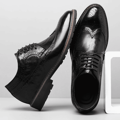 FORCIANO CELSUS black leather elevator dress shoes shown as a pair from side and top angles with lace-up brogue detailing.