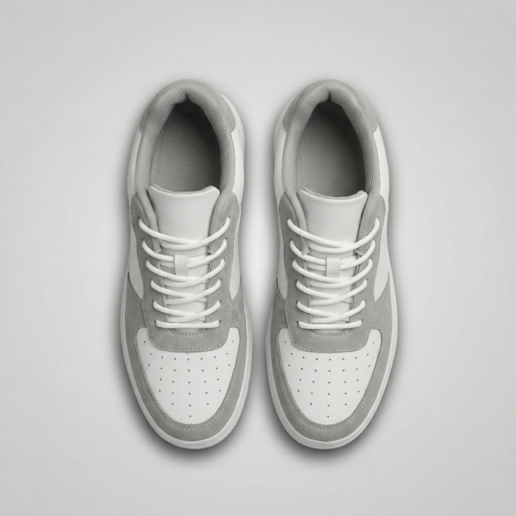 FORCIANO CHAMPION white and gray Hidden Lift Sneakers shown as a pair from the top with gray trim, white laces, and perforated toes.