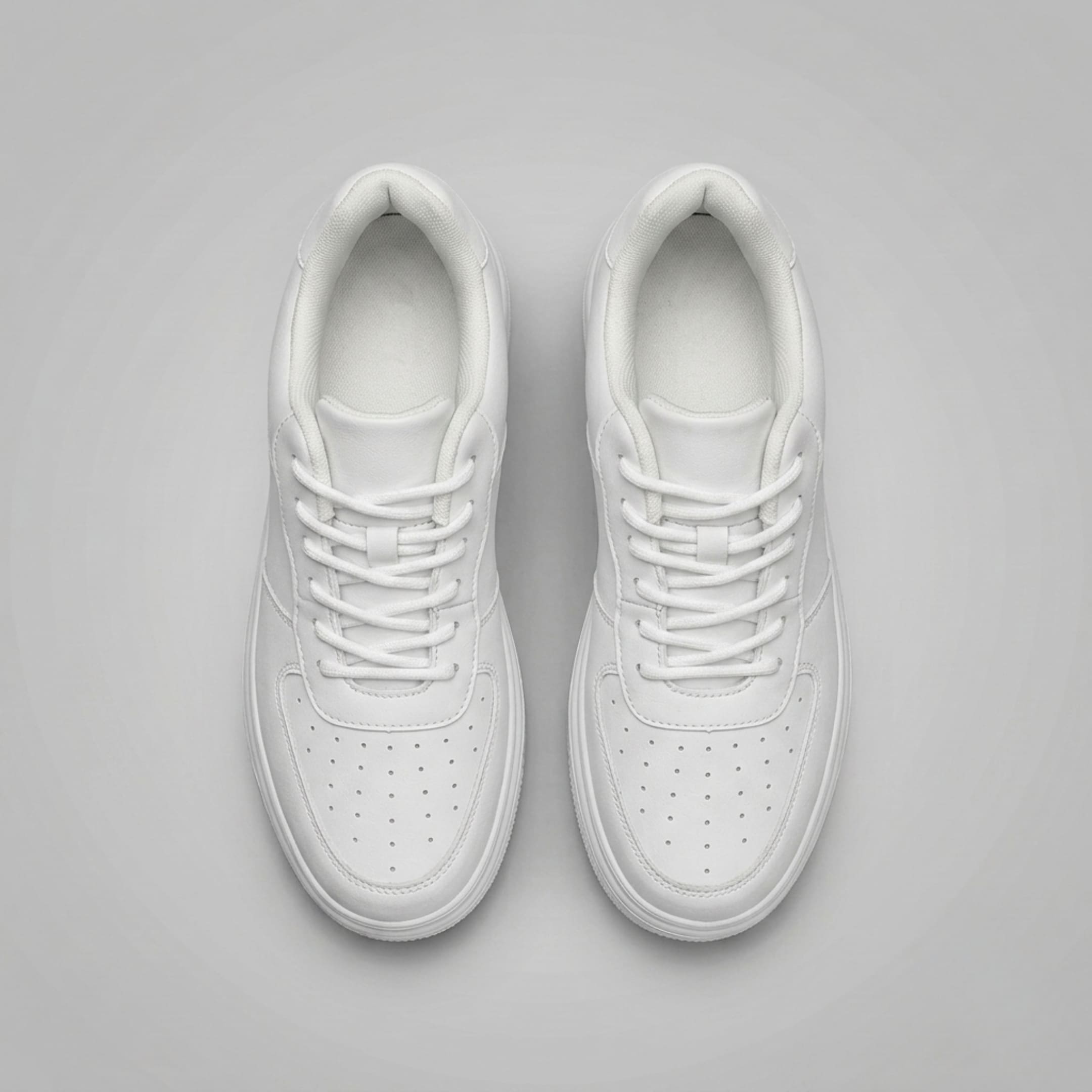 FORCIANO CHAMPION white sneakers displayed as a pair from the top, showing white laces, padded openings, and perforated toe panels.