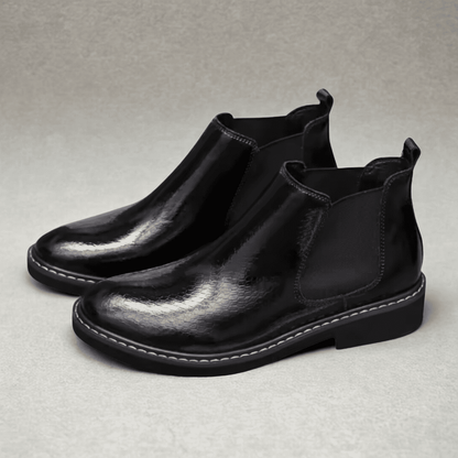 FORCIANO CROXTON black textured leather elevator Chelsea boots shown as a pair from a front three-quarter angle.