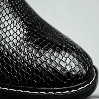 FORCIANO CROXTON black textured leather boot close-up showing the glossy toe finish and contrast welt stitching.