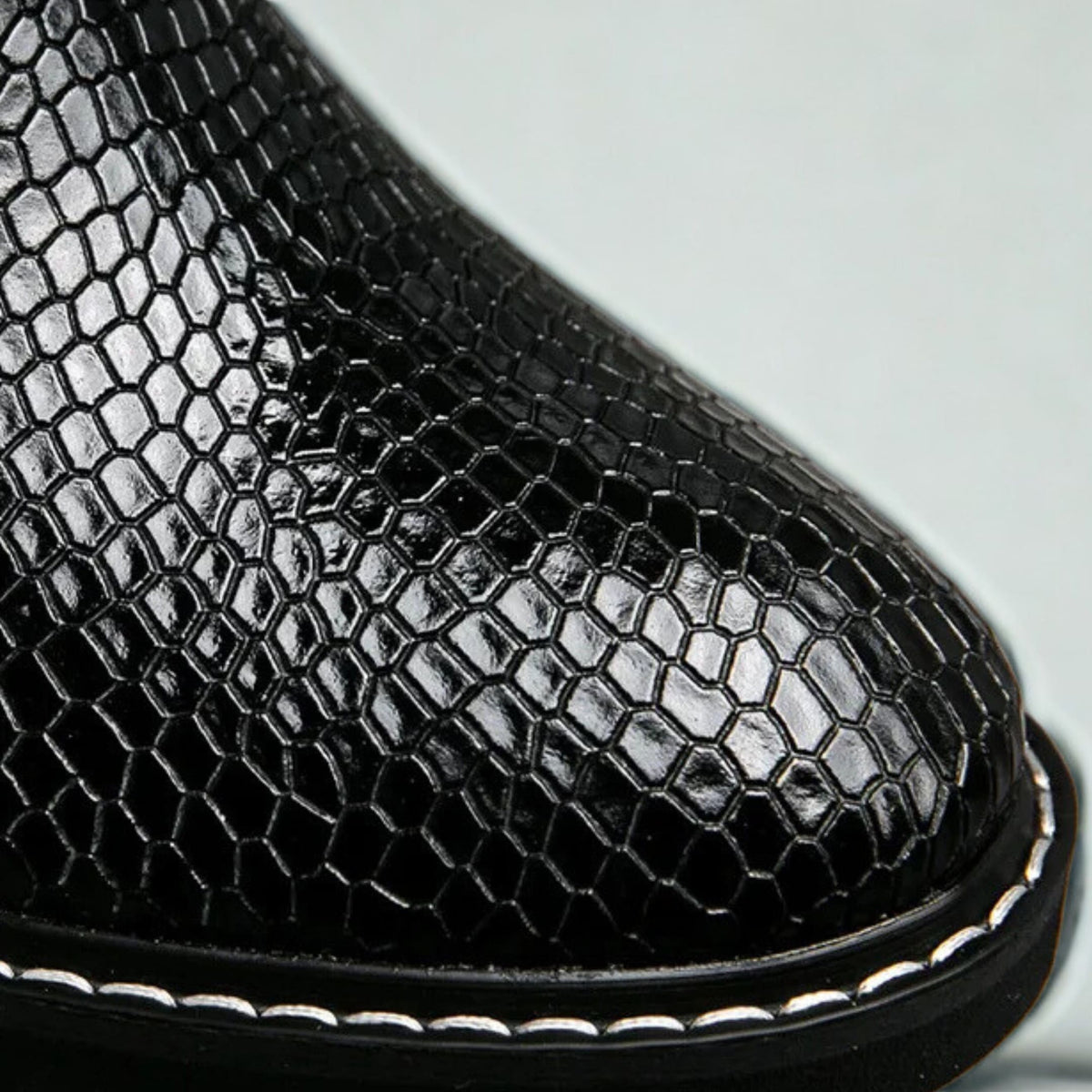 FORCIANO CROXTON Elevator Boots in black premium leather shown in a close-up of the glossy textured upper and welt stitching
