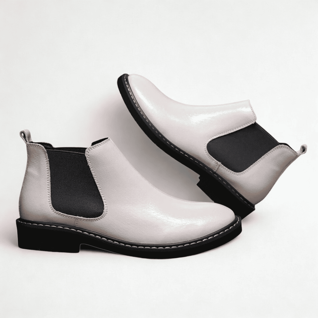 FORCIANO CROXTON white leather Chelsea boots arranged in a paired side-angle composition with black elastic side panels visible.
