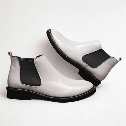 FORCIANO CROXTON white leather Chelsea boots arranged in a paired side-angle composition with black elastic side panels visible.