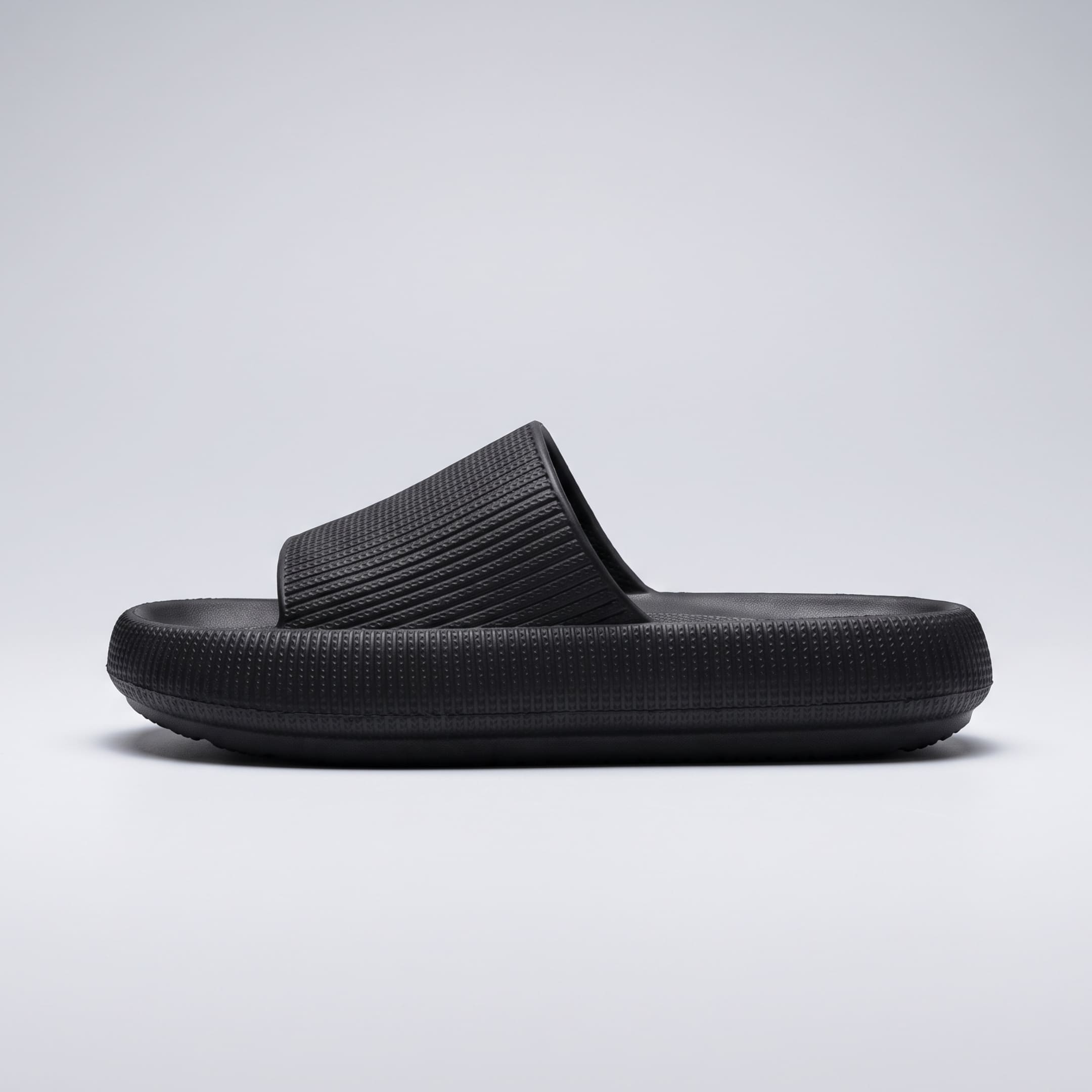FORCIANO DUNE black height increasing shoes shown in side profile with a wide textured strap and cushioned sole visible.