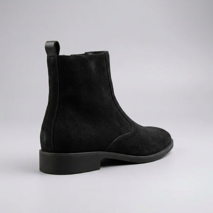 FORCIANO ECLIPSE black suede Chelsea boot in rear three-quarter view showing the heel construction, pull tab and black sole.