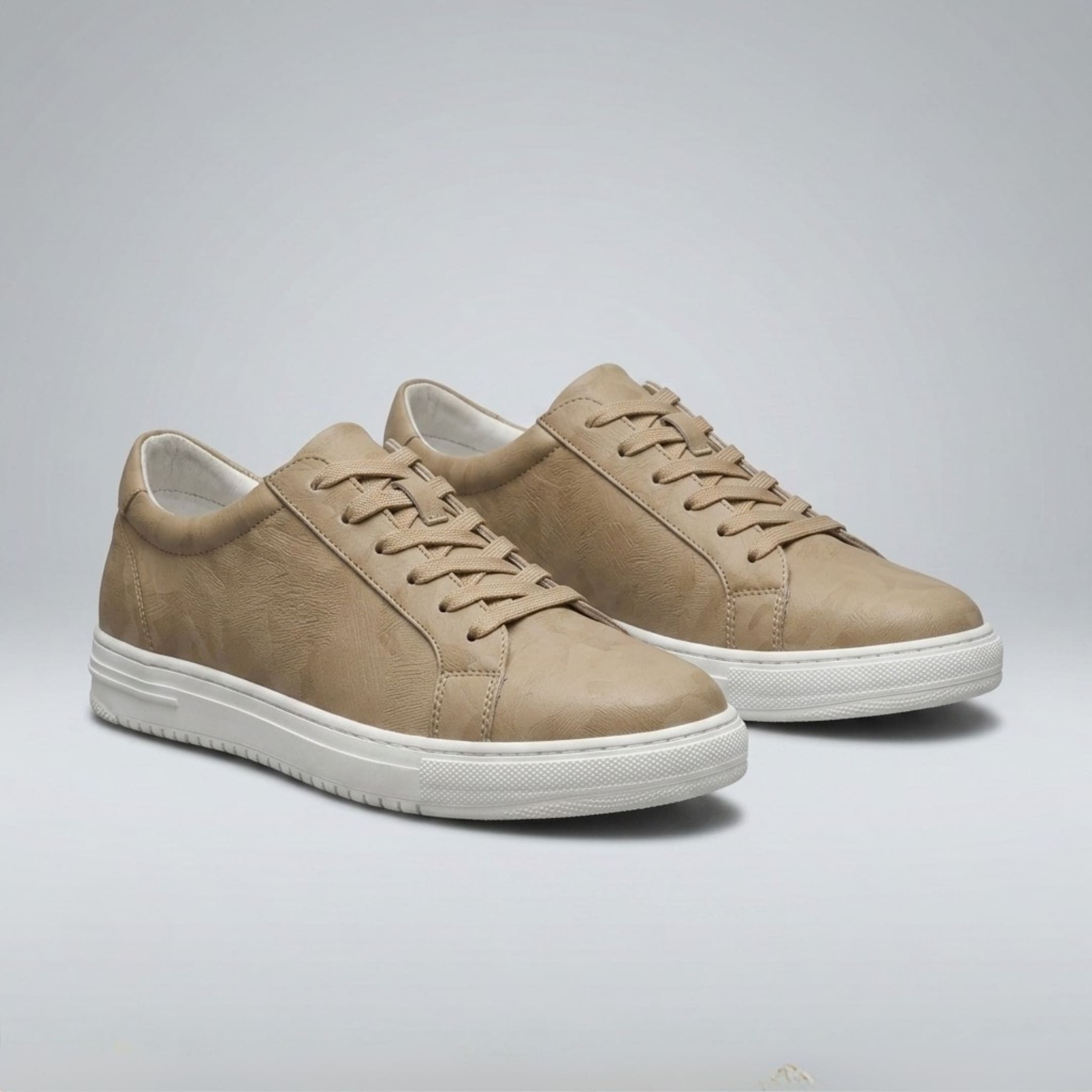 Pair of FORCIANO ELEMENT beige Height Increasing Sneakers in premium leather shown from a front three-quarter angle with tonal laces and white soles.