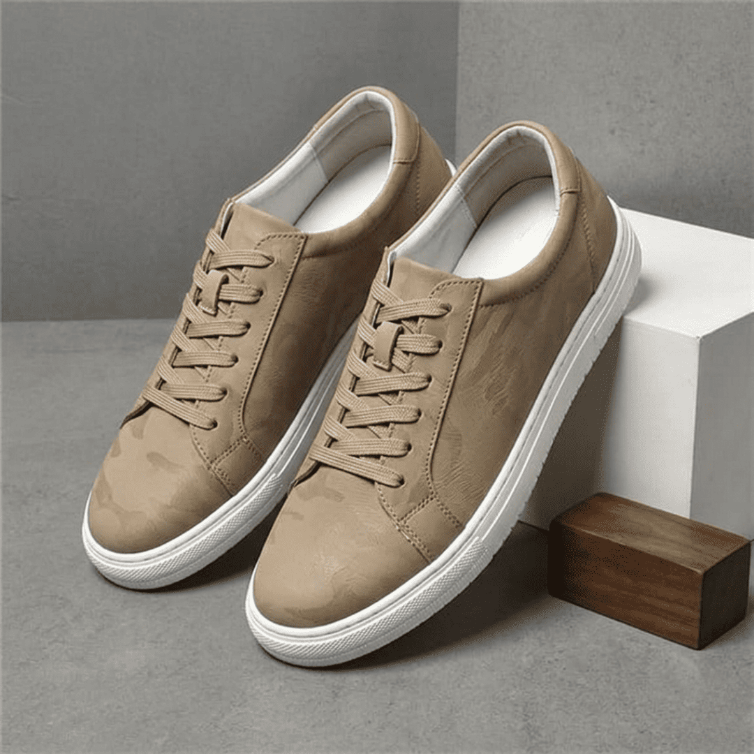 Pair of FORCIANO ELEMENT beige premium leather Height increasing sneakers shown from a raised front angle beside white and wooden display blocks.
