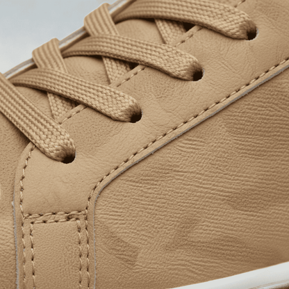 Close-up of the FORCIANO ELEMENT beige premium leather upper Height increasing sneaker showing matching laces, eyelets, stitching, and textured surface detail.