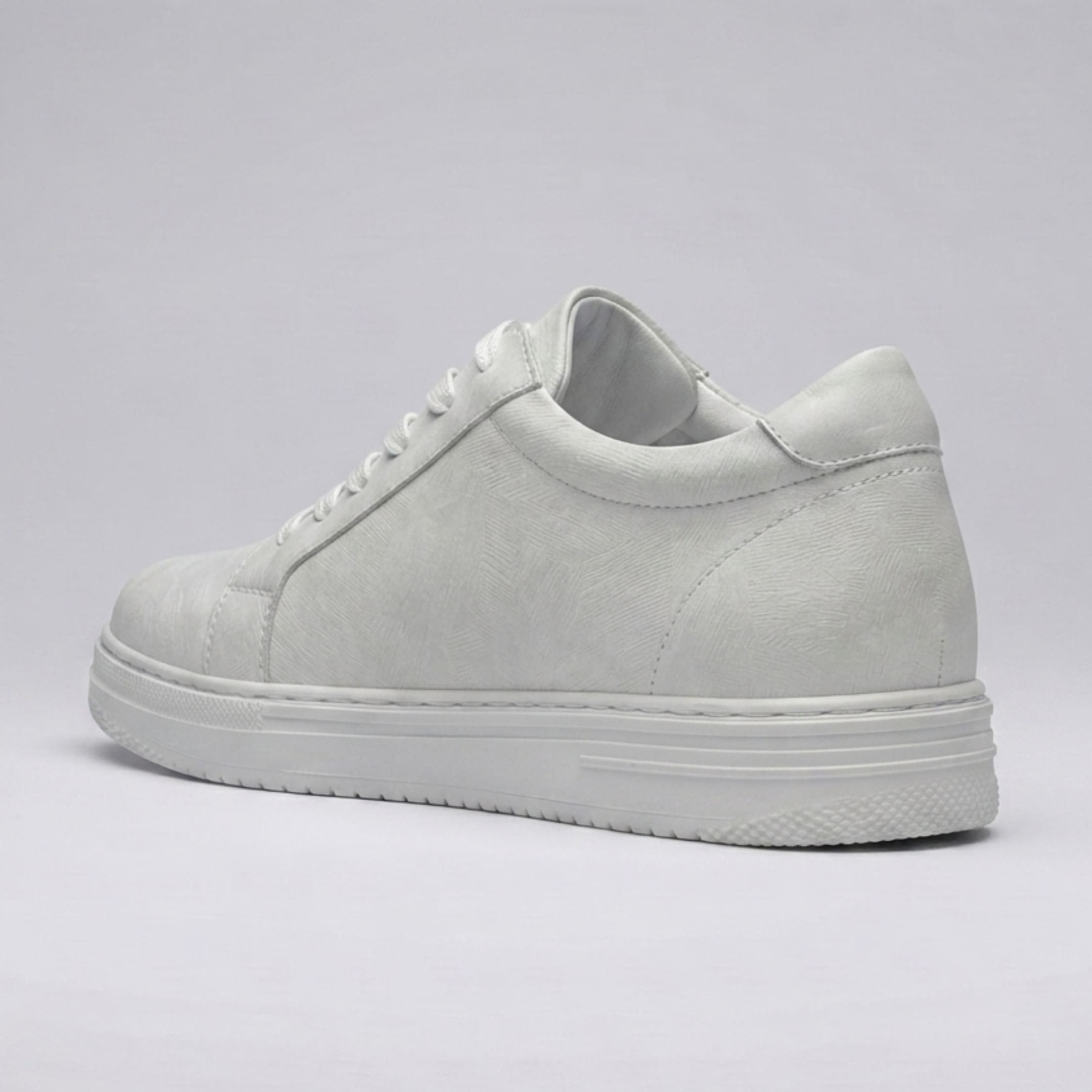 Rear three-quarter view of the FORCIANO ELEMENT white premium leather Height increasing sneaker showing its stitched heel panel, tonal upper, and white sole.