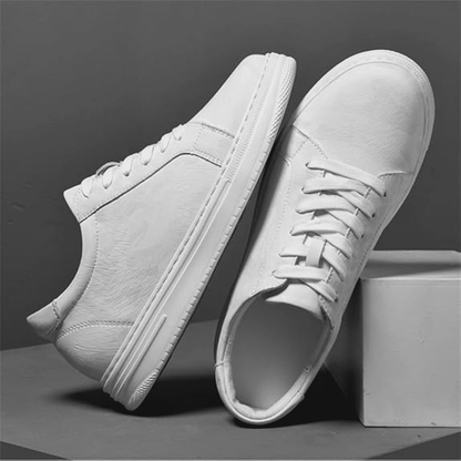 Pair of FORCIANO ELEMENT white premium leather sneakers arranged in side and top views on a gray studio display.