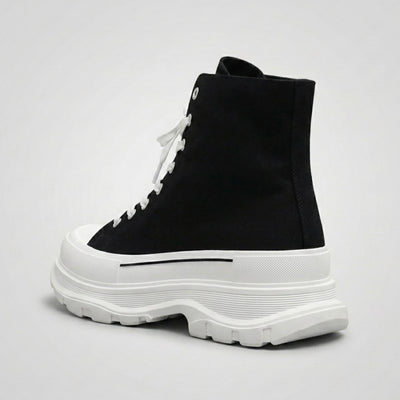 FORCIANO ELEVATOR black and white height increasing sneaker with thick cushioned sole shown from a rear three-quarter angle.
