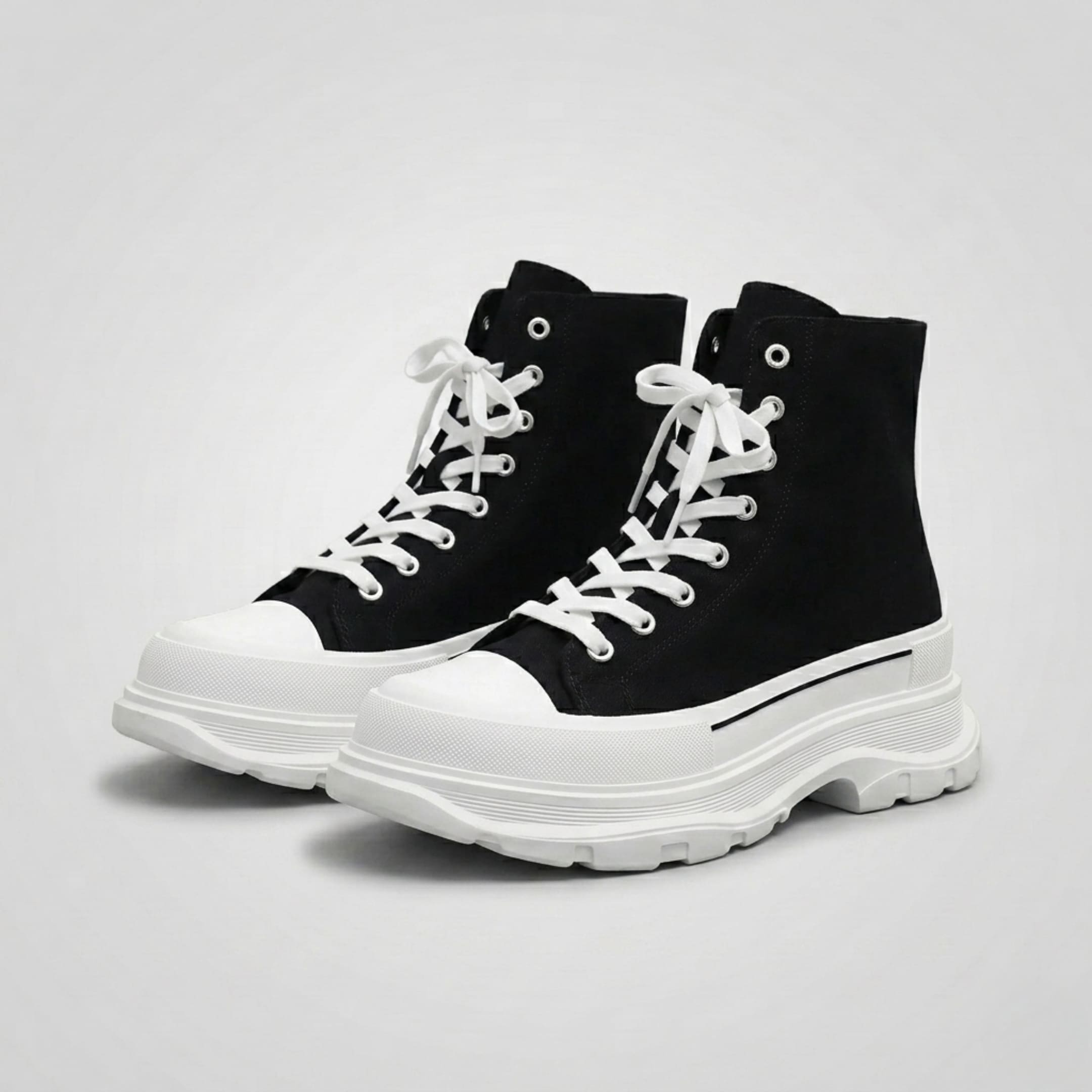 FORCIANO ELEVATOR black and white height increasing sneakers with thick cushioned high-top construction shown as a pair from a front three-quarter angle.