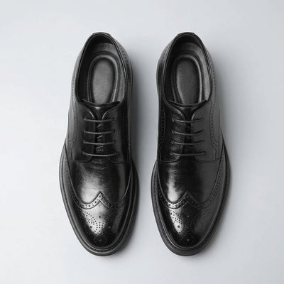 Top view of a pair of FORCIANO FAIRMONT black height increasing dress shoes showing laces, openings and brogue toe detailing.