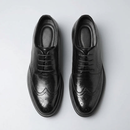Top view of a pair of FORCIANO FAIRMONT black height increasing dress shoes showing laces, openings and brogue toe detailing.