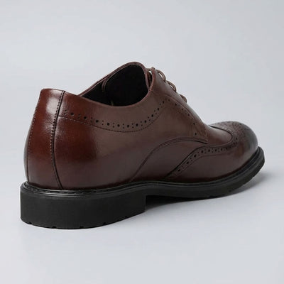 Rear three-quarter view of a FORCIANO FAIRMONT brown height increasing dress shoe showing the heel, side panels and brogue details.