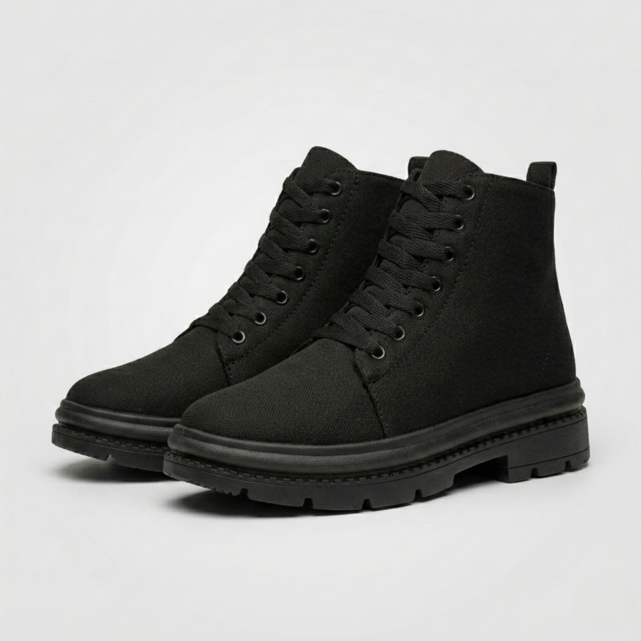 Pair of FORCIANO FORTITUDE black elevator boots shown from a front three-quarter angle with lace-up styling and black lug soles.