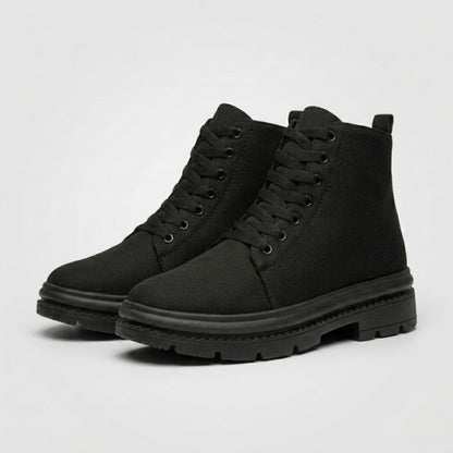 Pair of FORCIANO FORTITUDE black elevator boots shown from a front three-quarter angle with lace-up styling and black lug soles.