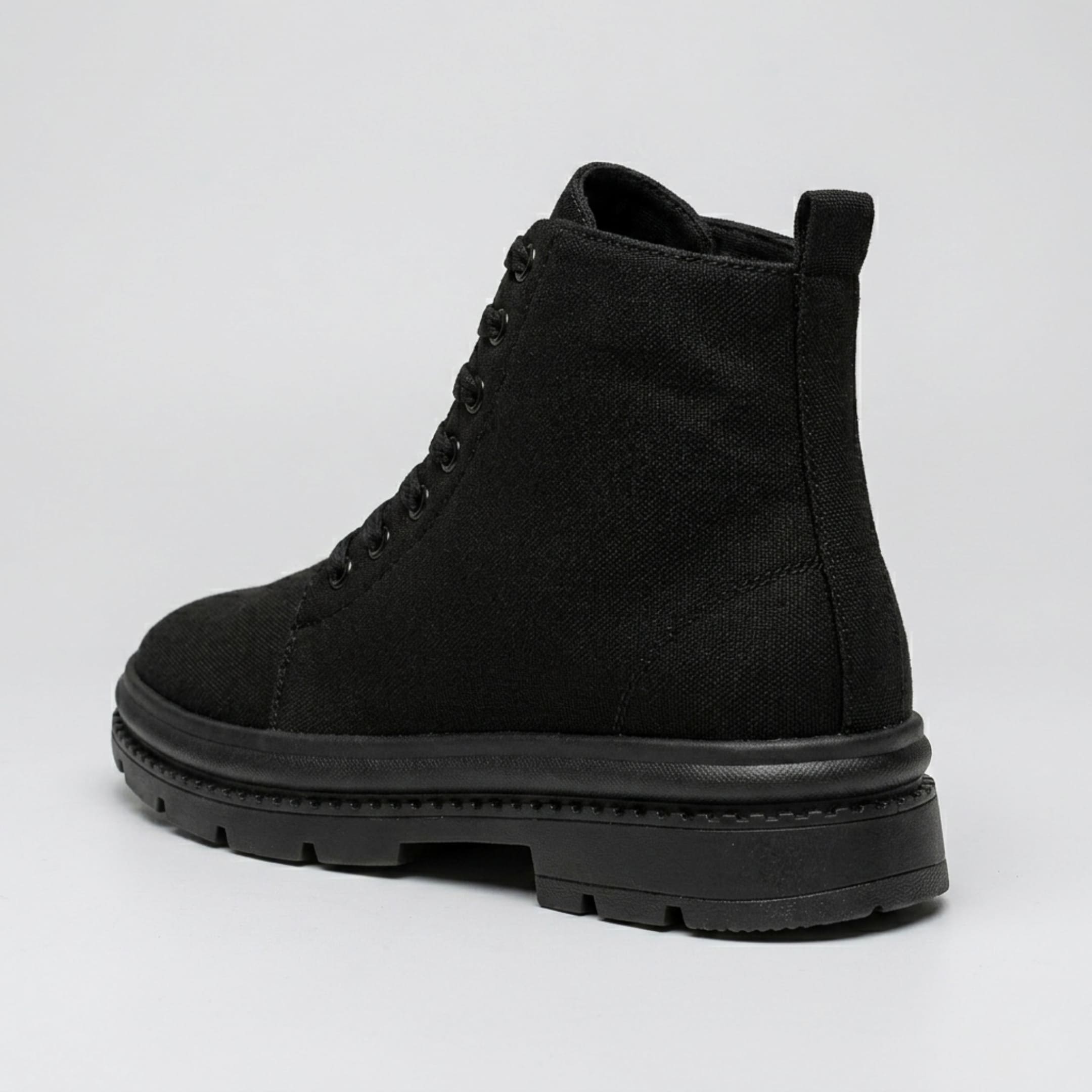 FORCIANO FORTITUDE black elevator boots shown from a rear three-quarter angle with lace-up construction and black lug sole.