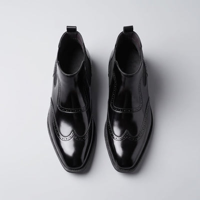 FORCIANO FORTRESS black Elevator Boots shown as a pair from the top view with polished finish and decorative perforated accents.