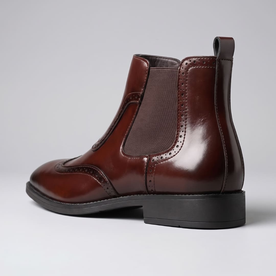 Rear three-quarter view of dark brown FORCIANO FORTRESS Elevator Boots showing the leather upper, heel, and side panel