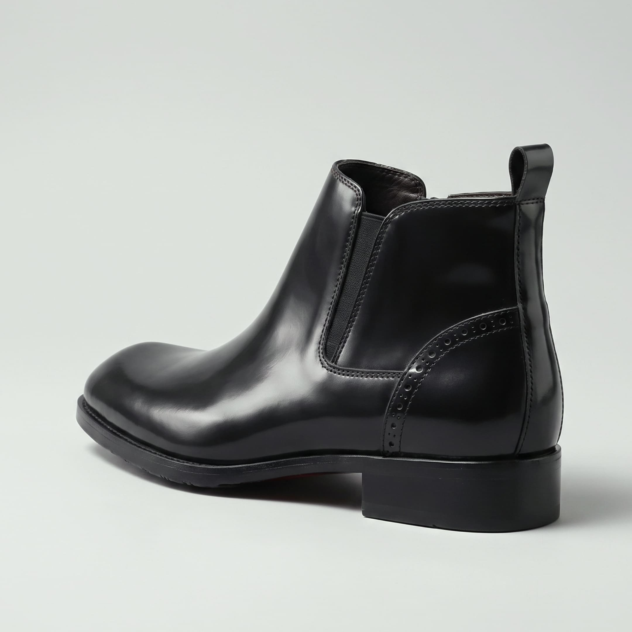 FORCIANO GARDA FOR MEN black elevator boots with genuine leather upper shown from a rear-side angle with elastic panel and pull tab.