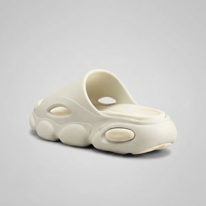 FORCIANO GLOW beige and white Height Increasing Slippers for Women shown from a rear three-quarter angle with the sculpted EVA sole and side openings visible.