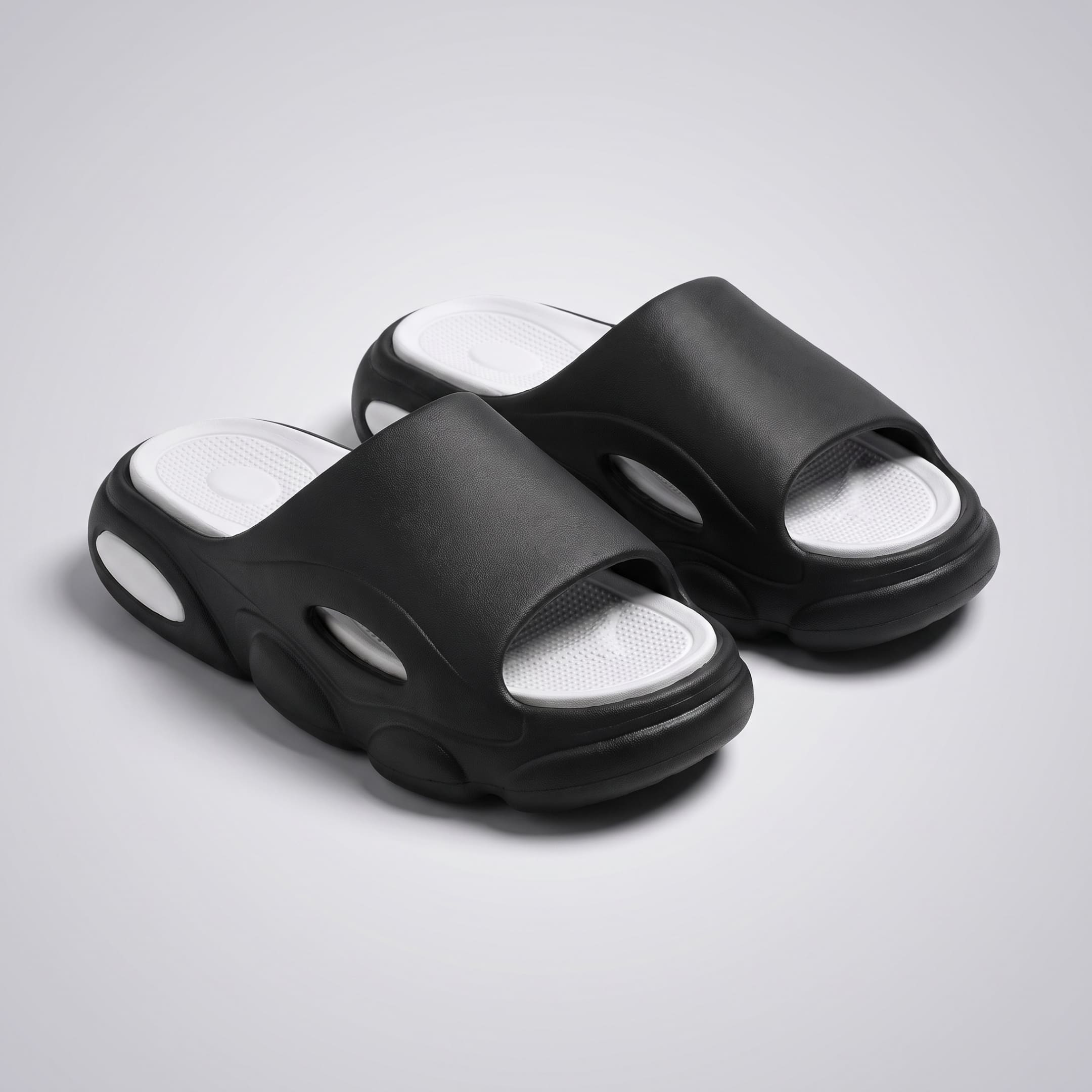 FORCIANO GLOW black and white Height Increasing Slippers for Women shown as a pair from a front three-quarter angle with cushioned footbeds visible.