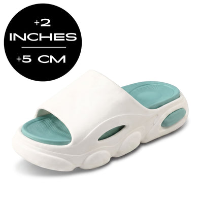 FORCIANO GLOW Height Increasing Slippers for Women in white and green with ultra-soft EVA construction, shown at a front three-quarter angle with 5 cm / 2 inches height graphic.