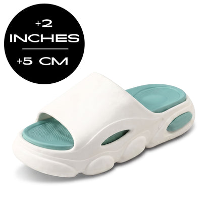 FORCIANO GLOW Height Increasing Slippers for Women in white and green with ultra-soft EVA construction, shown at a front three-quarter angle with 5 cm / 2 inches height graphic.