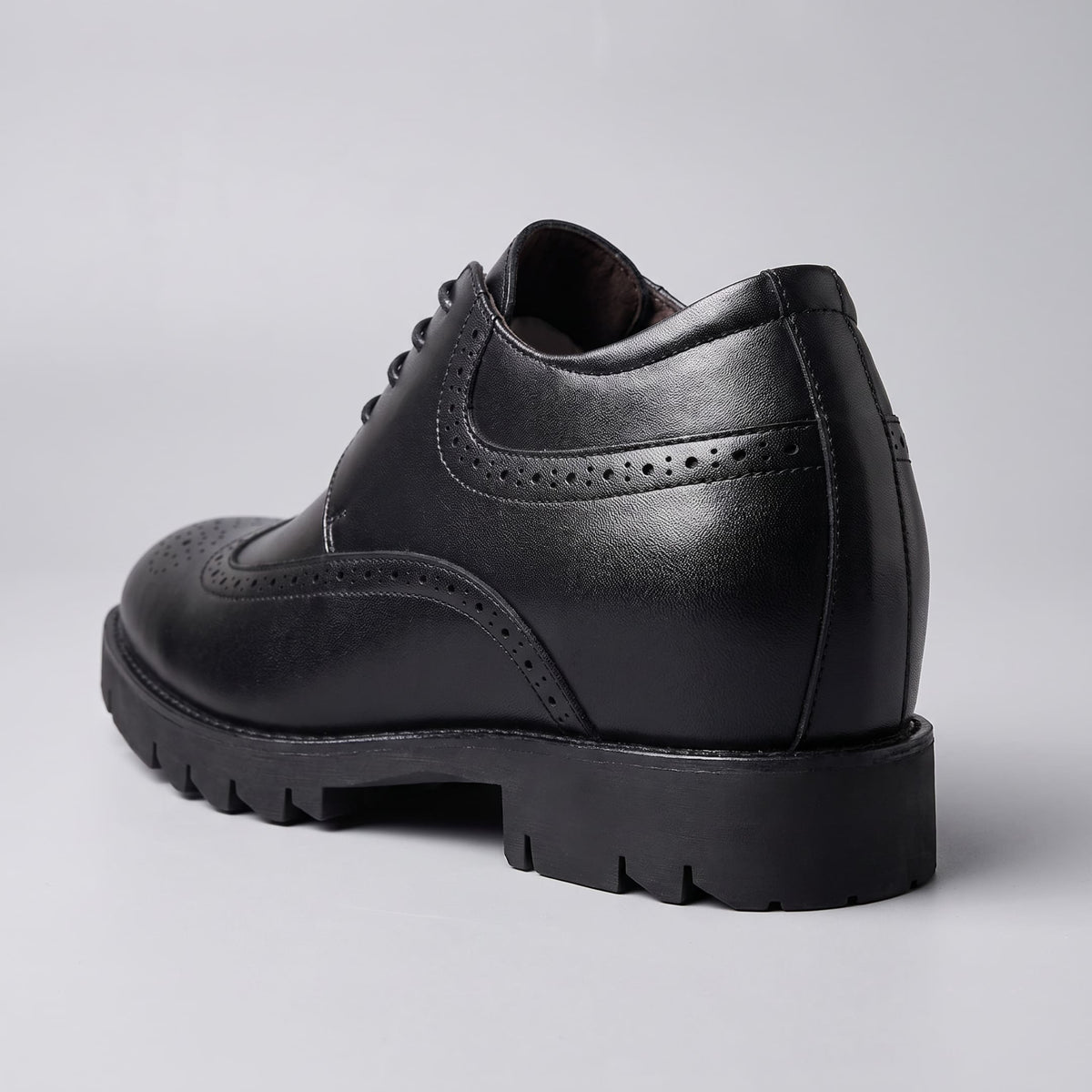 FORCIANO GRANDIOR black Height Increasing Shoes shown from a rear three-quarter angle with premium leather upper and perforated side detailing.
