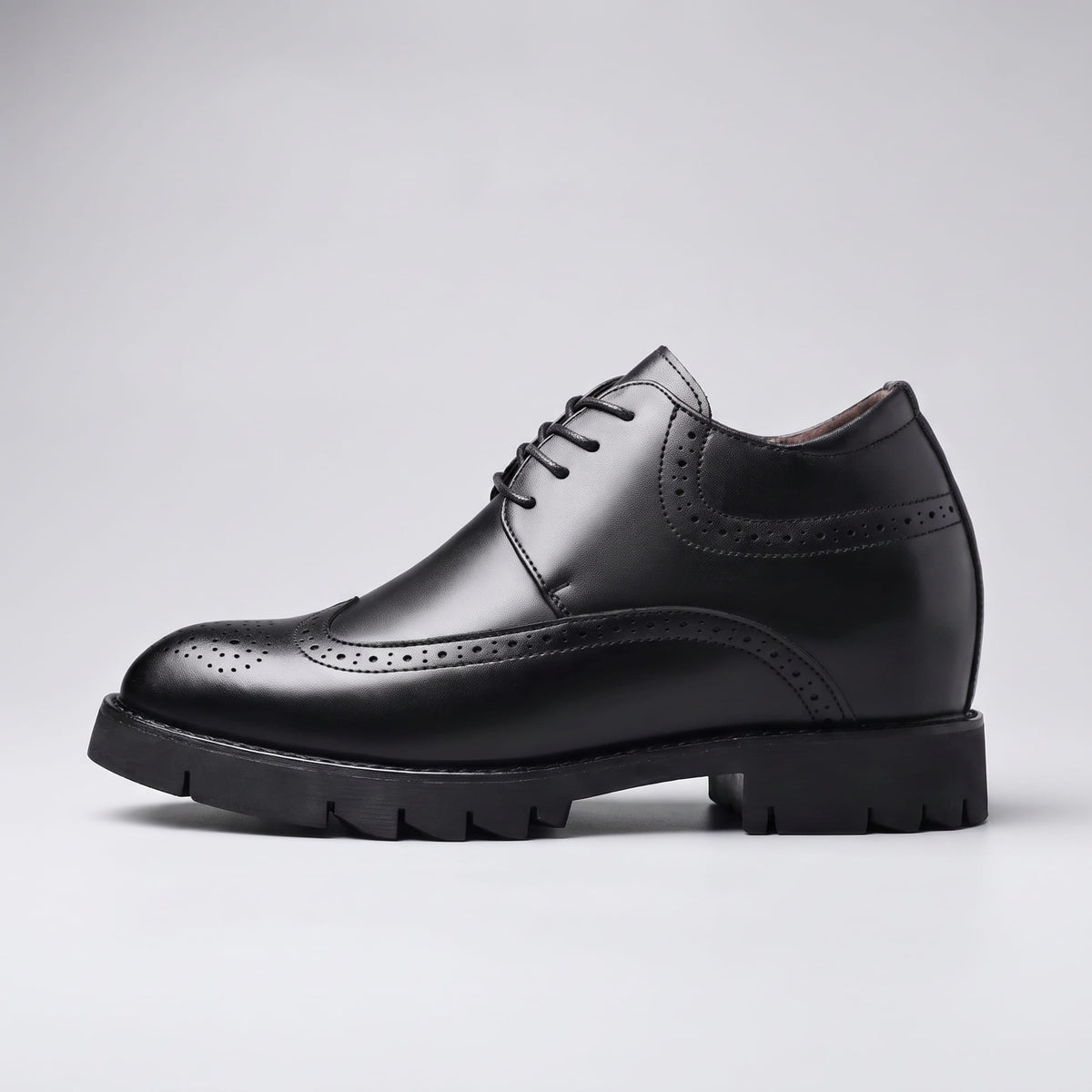 FORCIANO GRANDIOR black Height Increasing Shoes shown in side profile with premium leather upper, lace closure and decorative perforations.