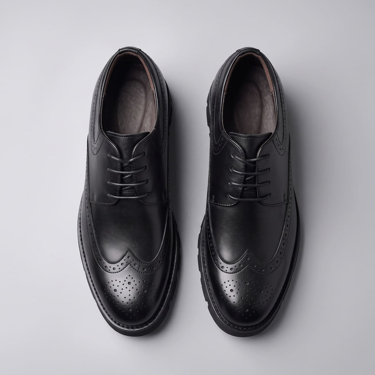 FORCIANO GRANDIOR black Height Increasing Shoes shown as a pair from the top with premium leather uppers, leather lining and perforated detailing.